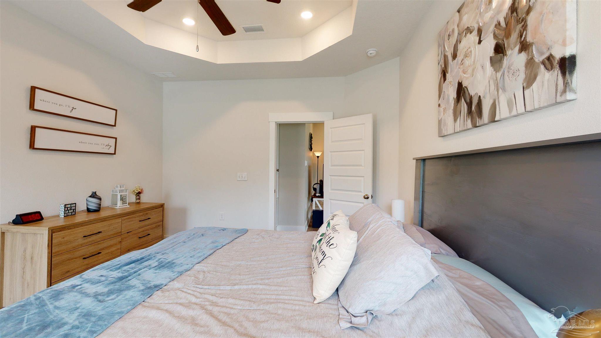 5789 Conley Court Milton, FL 32571 - Photo 28 of 50 a bedroom with a bed and a painting on the wall