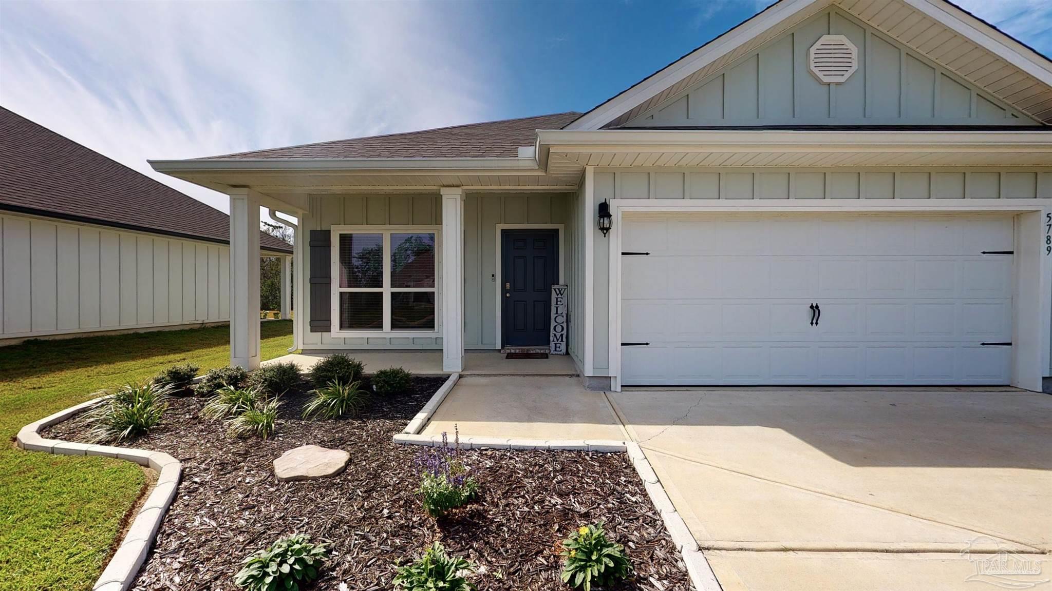 5789 Conley Court Milton, FL 32571 - Photo 4 of 50 a front view of a house with garden