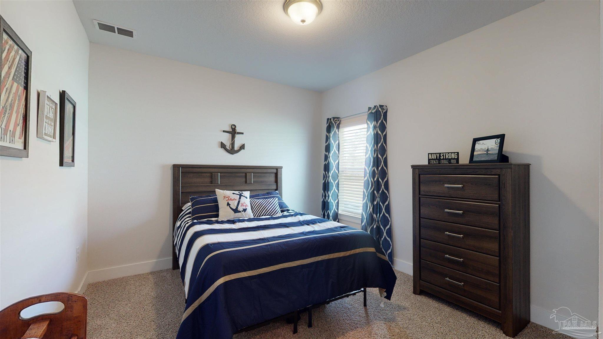 5789 Conley Court Milton, FL 32571 - Photo 32 of 50 a bedroom with a bed and a dresser