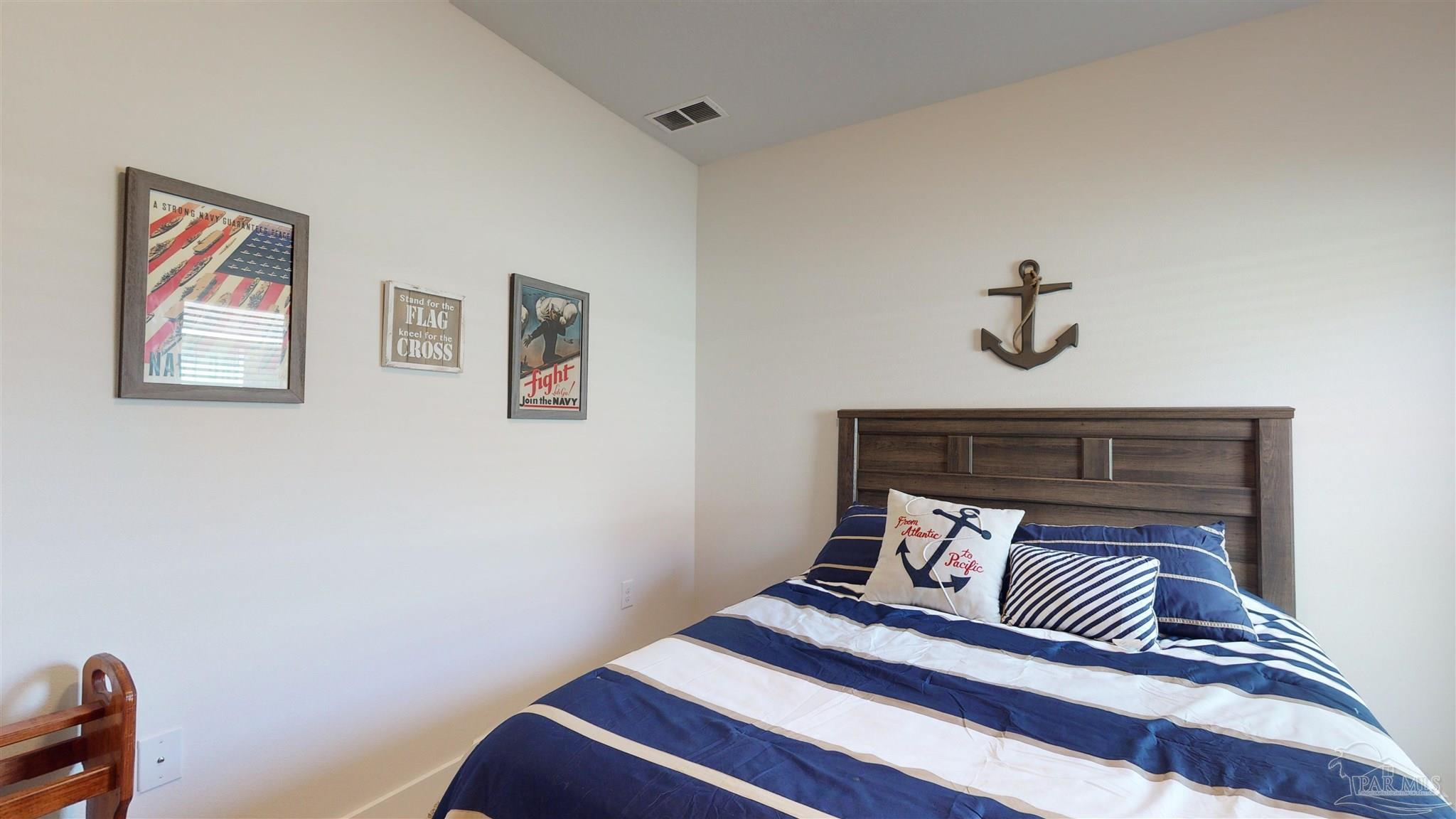 5789 Conley Court Milton, FL 32571 - Photo 34 of 50 a bedroom with a bed and a lamp on dresser