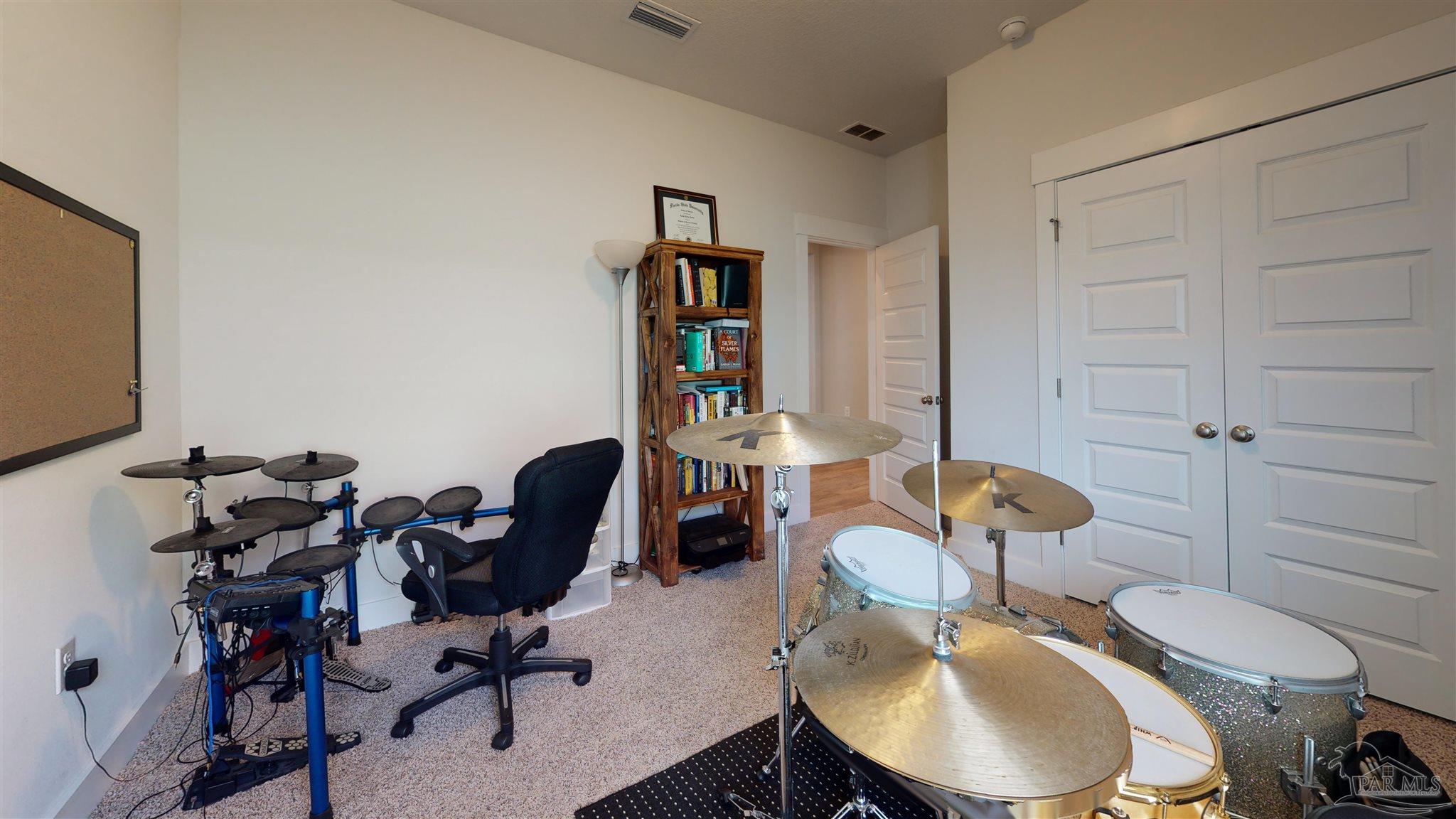 5789 Conley Court Milton, FL 32571 - Photo 37 of 50 a work room with furniture a rug and gym equipment