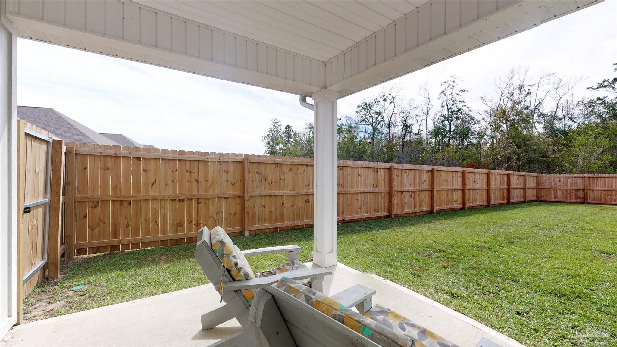 5789 Conley Court Milton, FL 32571 - Photo 42 of 50 a view of a backyard with chair and garden