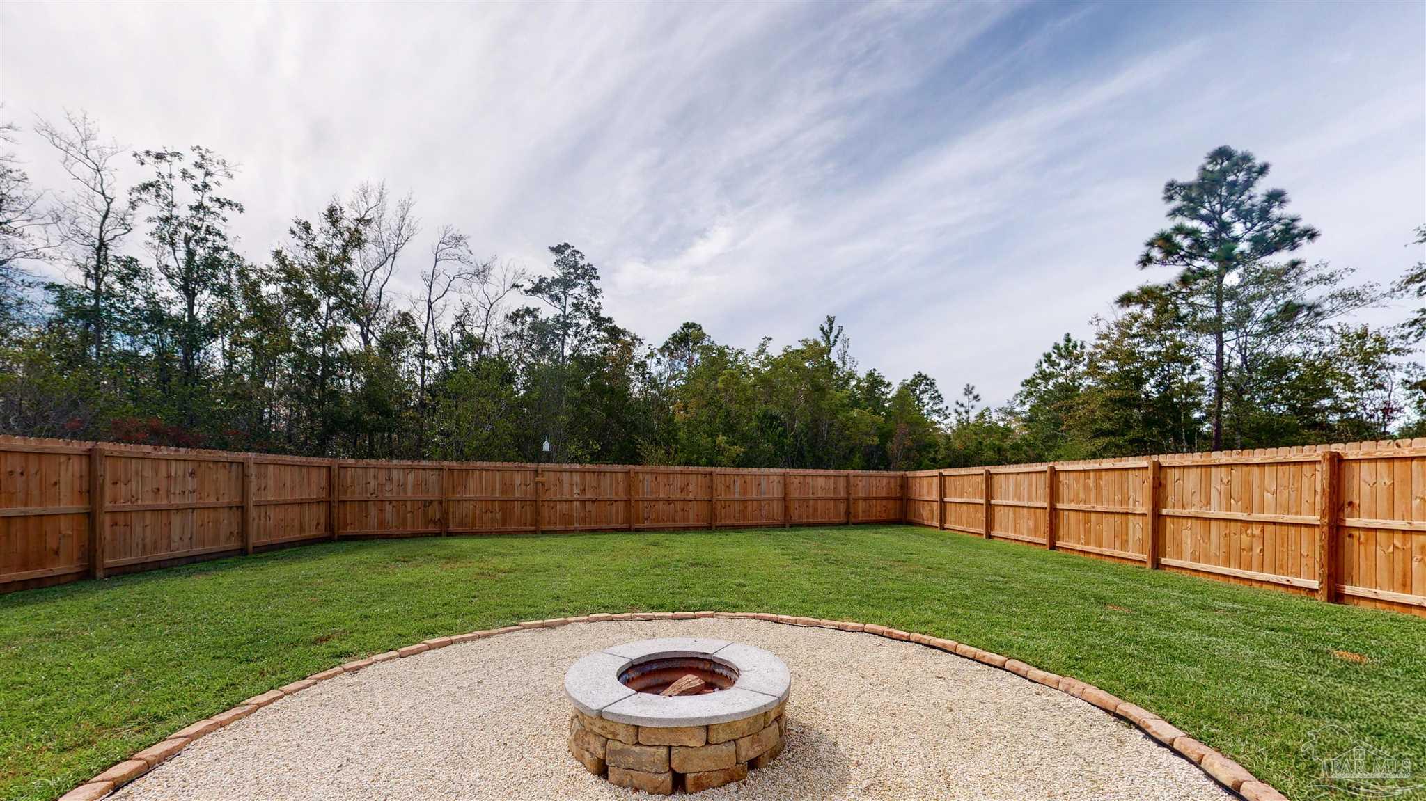5789 Conley Court Milton, FL 32571 - Photo 46 of 50 a view of yard with swimming pool and trees in the background