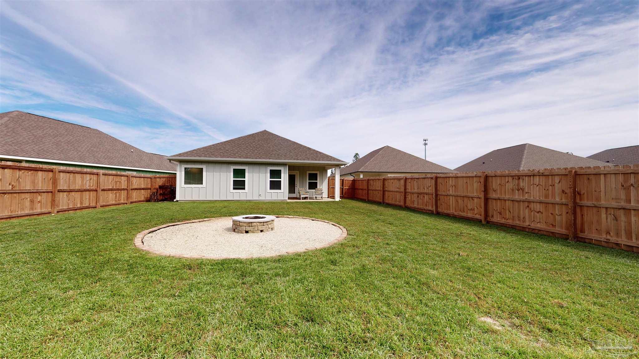 5789 Conley Court Milton, FL 32571 - Photo 48 of 50 a backyard of a house with wooden floor table and sofas