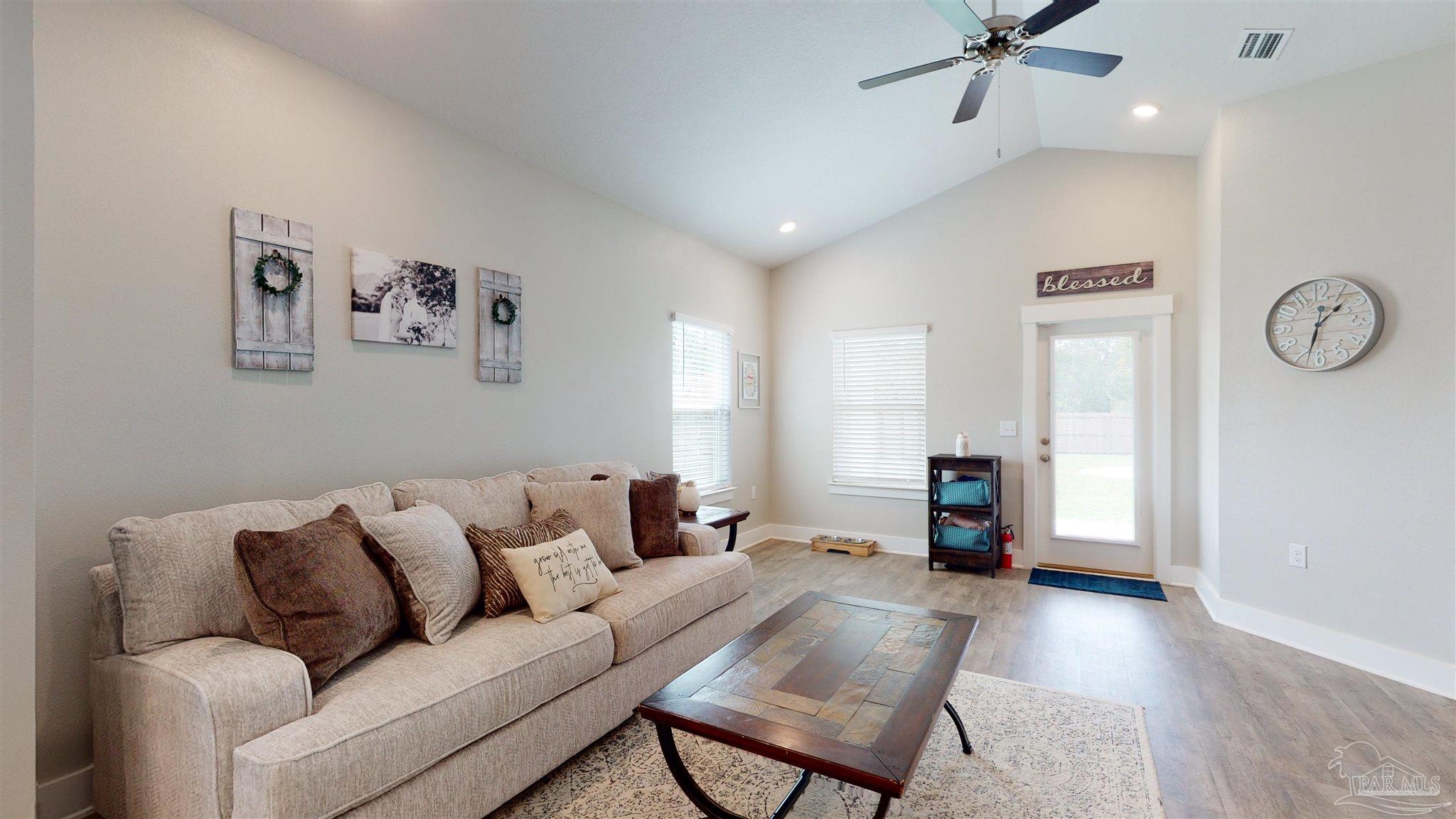 5789 Conley Court Milton, FL 32571 - Photo 9 of 50 a living room with furniture and a wooden floor