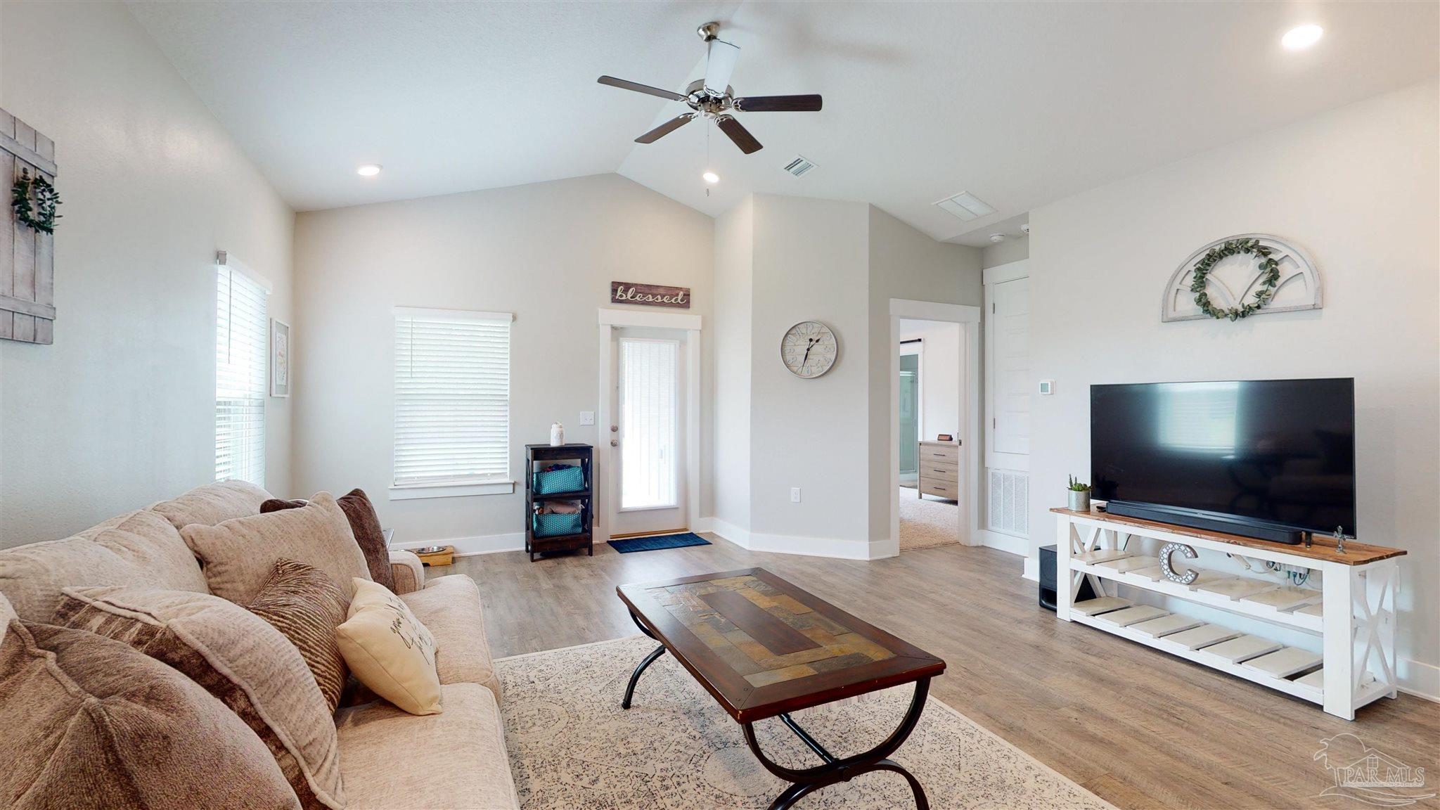 5789 Conley Court Milton, FL 32571 - Photo 10 of 50 a living room with furniture and a flat screen tv