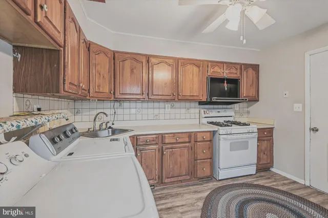 a living room with furniture a rug and a wooden floor