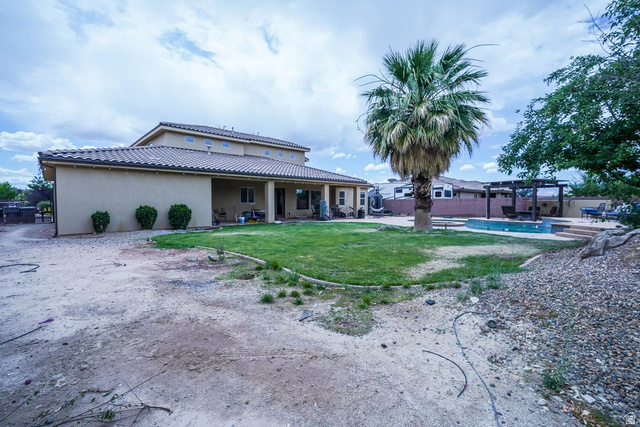3683 South 2640 West St. George, UT 84790 - Photo 37 of 41 Rear exterior featuring a tiled roof, covered patio, manicured lawn, and a swimming pool with an adjacent pergola