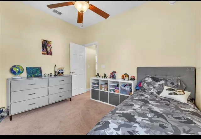 a bedroom with a bed and a chair