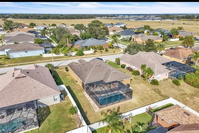 an aerial view of a residential houses with outdoor space