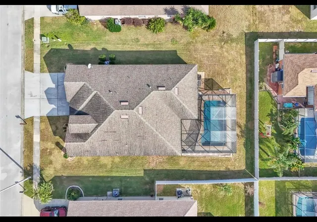 an aerial view of residential houses with outdoor space