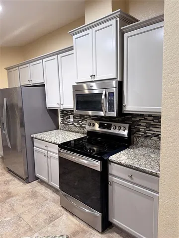a kitchen with a refrigerator sink and stove
