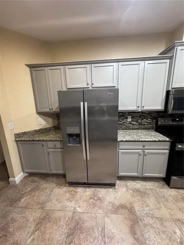 a white cabinets with granite top