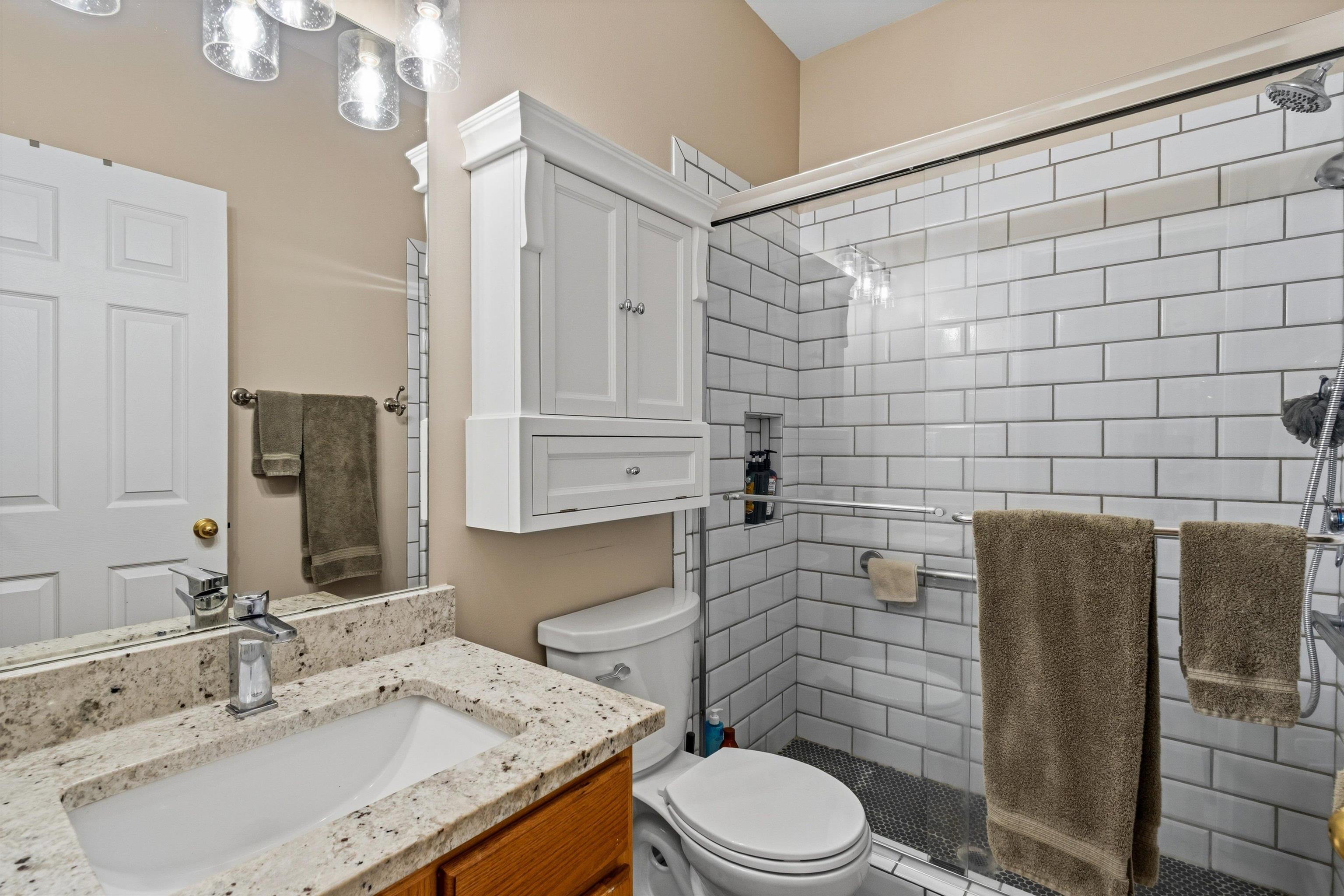10496 Ashfarm Way Collierville, TN 38017 - Photo 20 of 29 a bathroom with a granite countertop sink toilet and shower