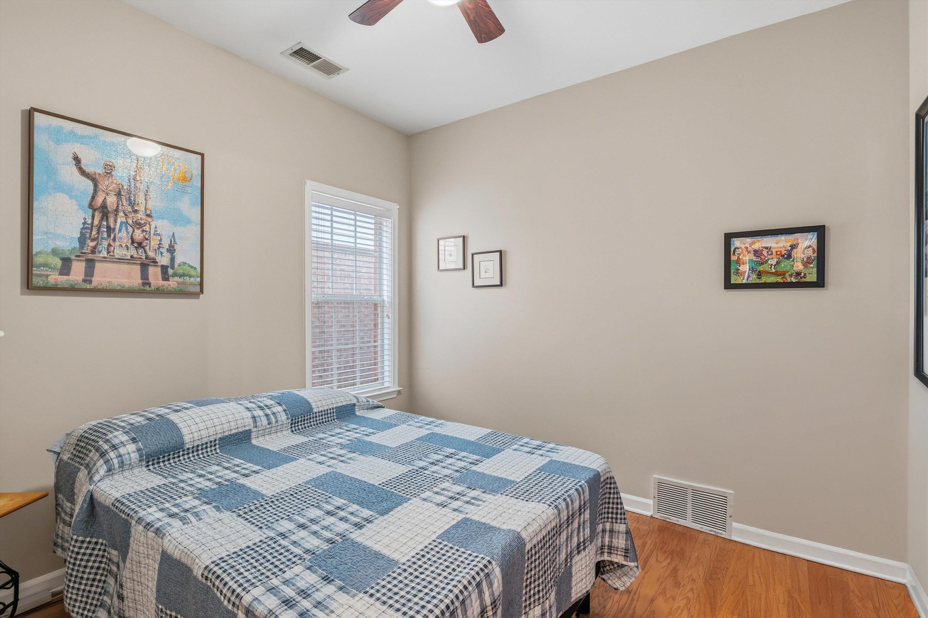 10496 Ashfarm Way Collierville, TN 38017 - Photo 21 of 29 a bedroom with a bed and a wall painting