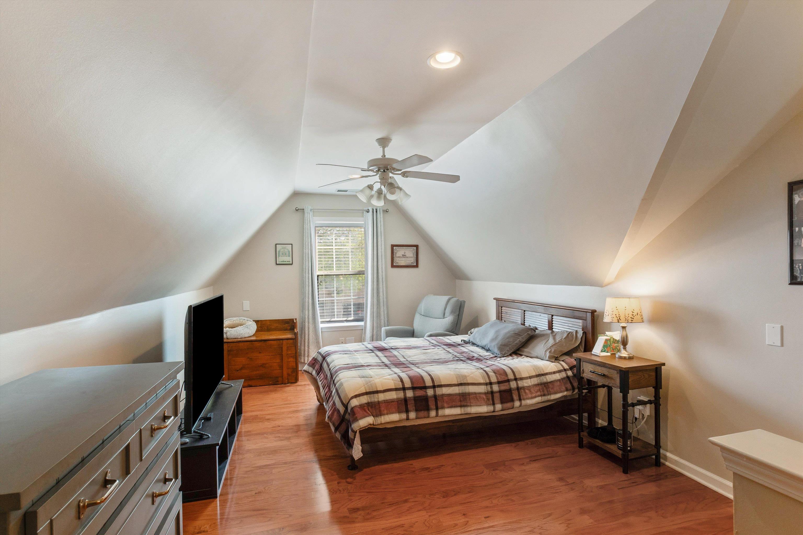 10496 Ashfarm Way Collierville, TN 38017 - Photo 23 of 29 a bedroom with a bed and a chandelier