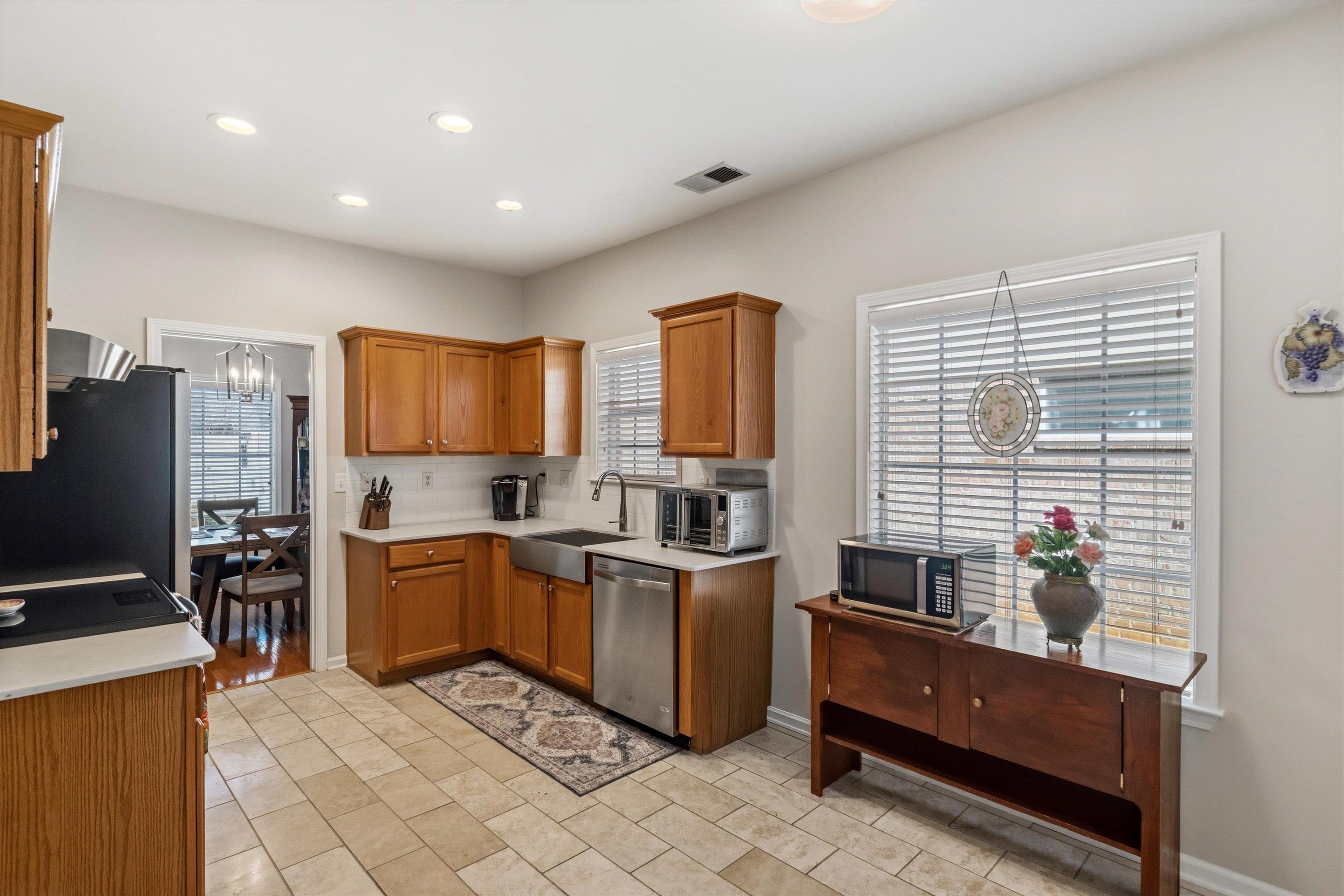 10496 Ashfarm Way Collierville, TN 38017 - Photo 7 of 29 a kitchen with stainless steel appliances granite countertop a stove a sink dishwasher and a refrigerator