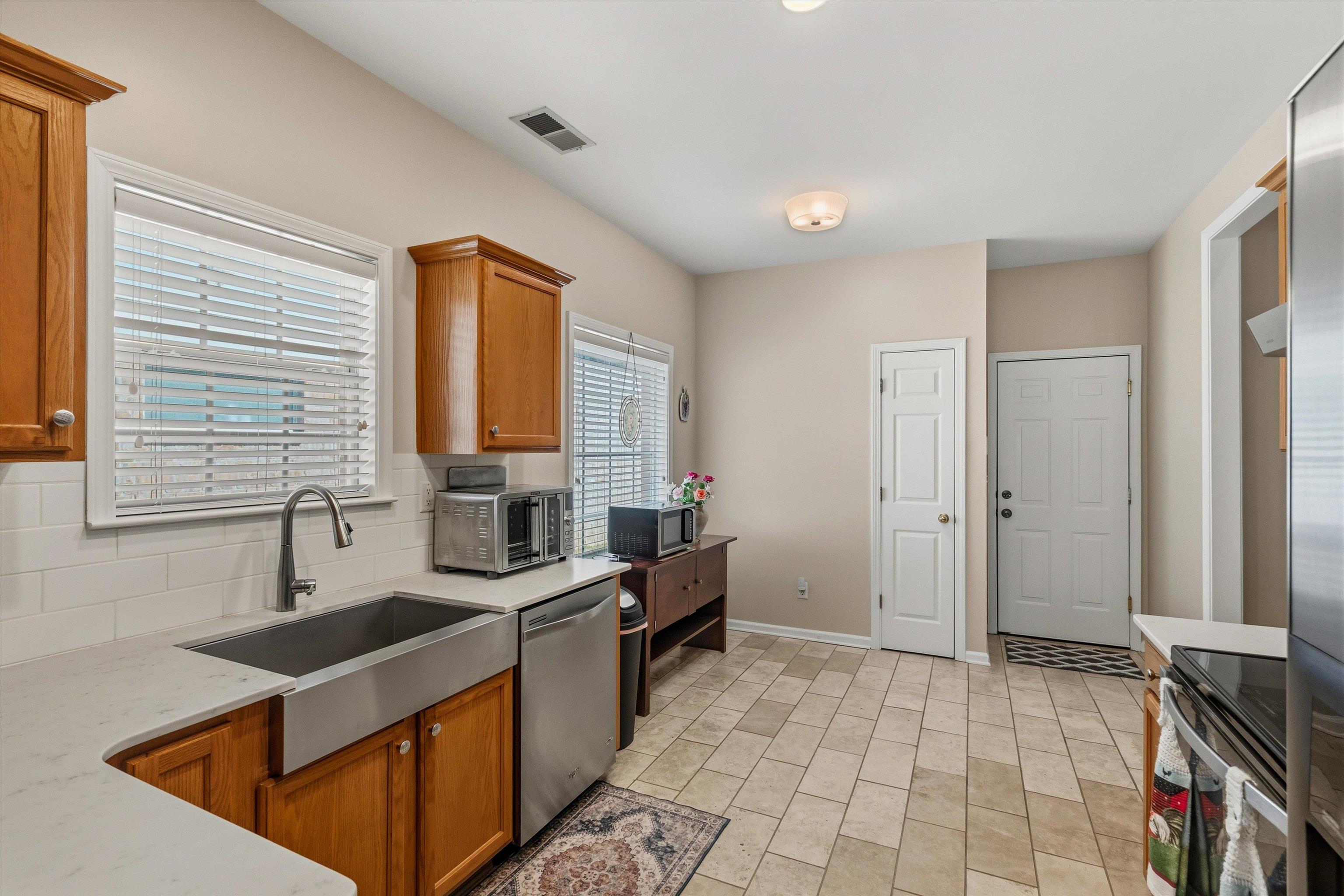 10496 Ashfarm Way Collierville, TN 38017 - Photo 9 of 29 a kitchen with stainless steel appliances granite countertop a sink stove and cabinets