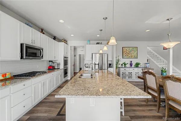 a kitchen with counter top space appliances and cabinets