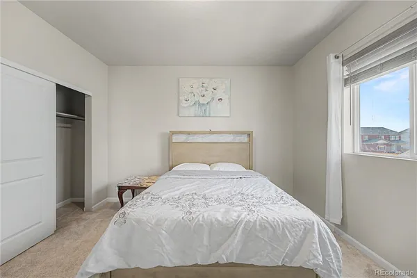 a bed sitting in a bedroom next to a window
