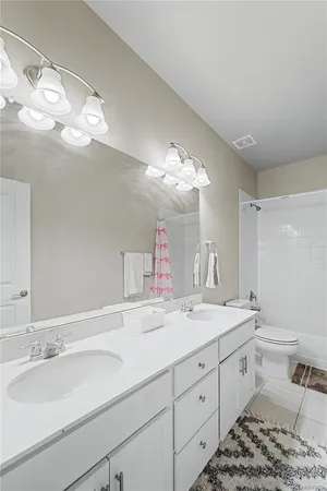 a bathroom with a sink a large mirror and vanity