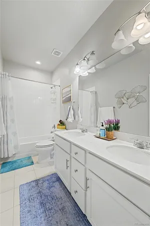 a bathroom with a tub sink and mirror