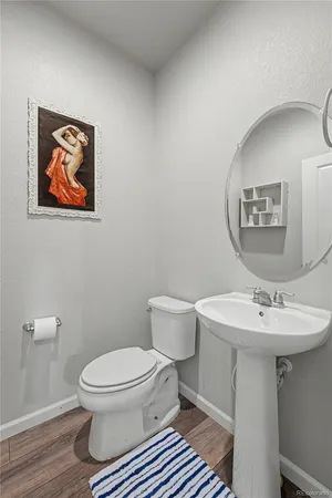 a bathroom with a toilet a sink and mirror