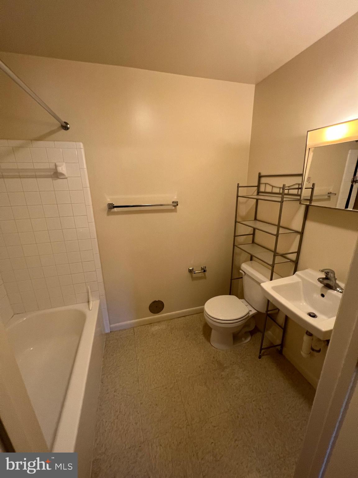 308 Broadway Street, Unit 101 Quantico, VA 22134 - Photo 3 of 6 a bathroom with a sink a toilet and shower