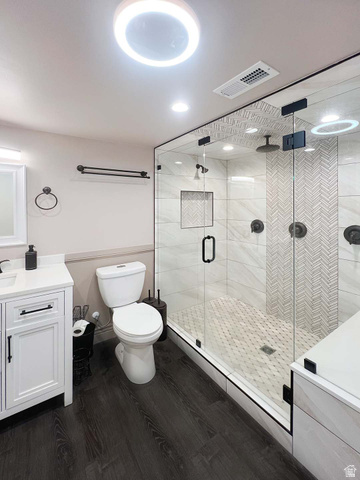 3138 Jean Street Magna, UT 84044 - Photo 19 of 26 Contemporary bathroom featuring a spacious glass-enclosed shower with dual shower heads, herringbone accent tiling, and a mosaic tile floor