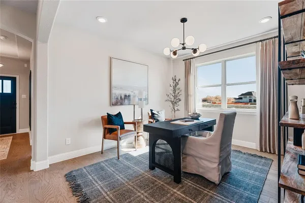 a hallway with a table and chairs