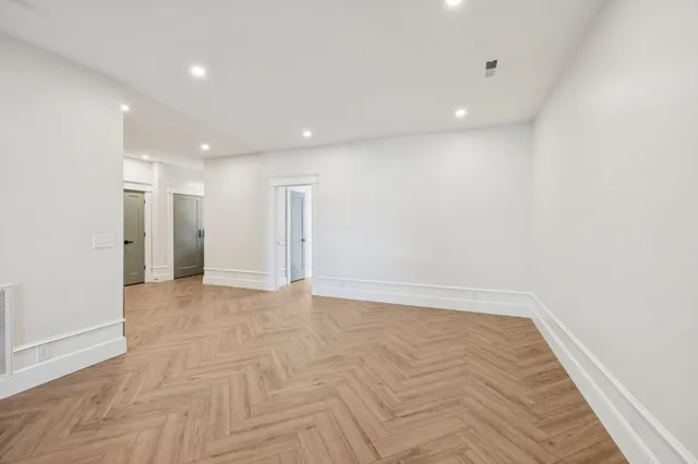 a view of empty room with cabinet and floor to ceiling window