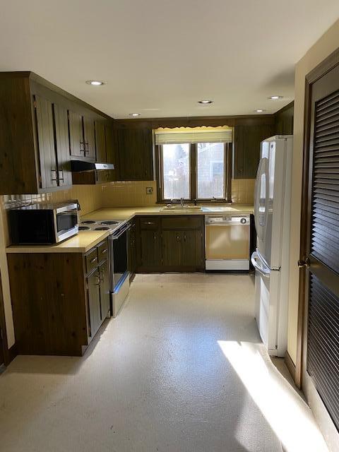 119 Sheaffer Road Centerville, MA 02632 - Photo 8 of 24 a kitchen with stainless steel appliances granite countertop a refrigerator a sink a stove and wooden cabinets