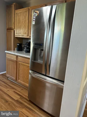 a metallic refrigerator freezer sitting in a kitchen