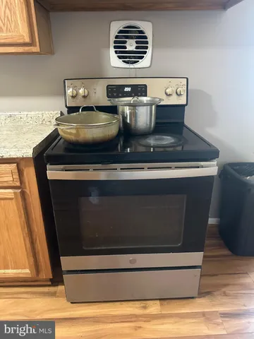 a stove top oven sitting inside of a kitchen