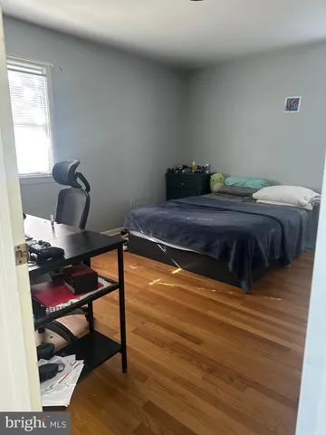 a bed sitting in a bedroom next to a window