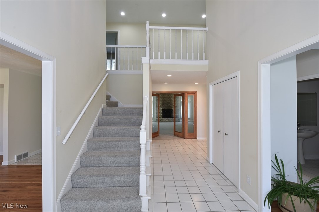 30776 Cedar Road Cleveland, OH 44124 - Photo 5 of 41 Stairs featuring a high ceiling, recessed lighting, and tile patterned floors