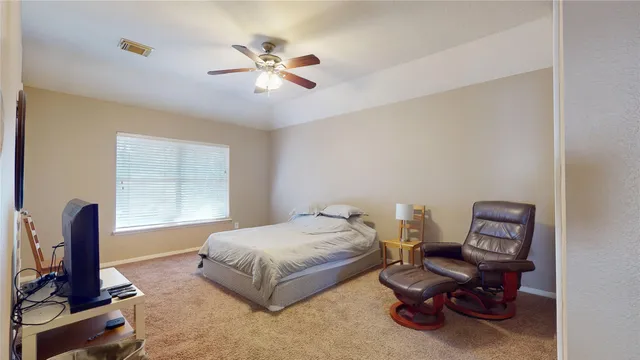 a bedroom with furniture and a window