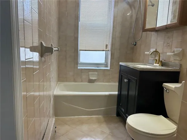 a bathroom with a toilet a sink and bathtub
