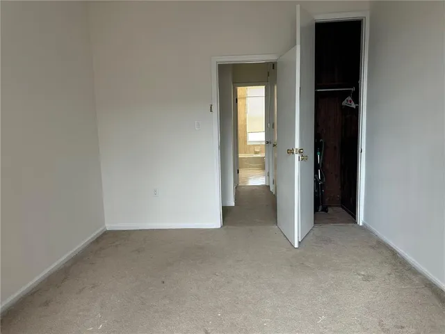 an empty room that has a grey walls