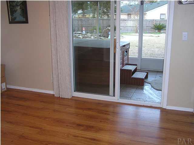 356 Quigley Road Pensacola, FL 32506 - Photo 3 of 15 Hard woods in master bedroom* Sliding glass doors to screened patio.