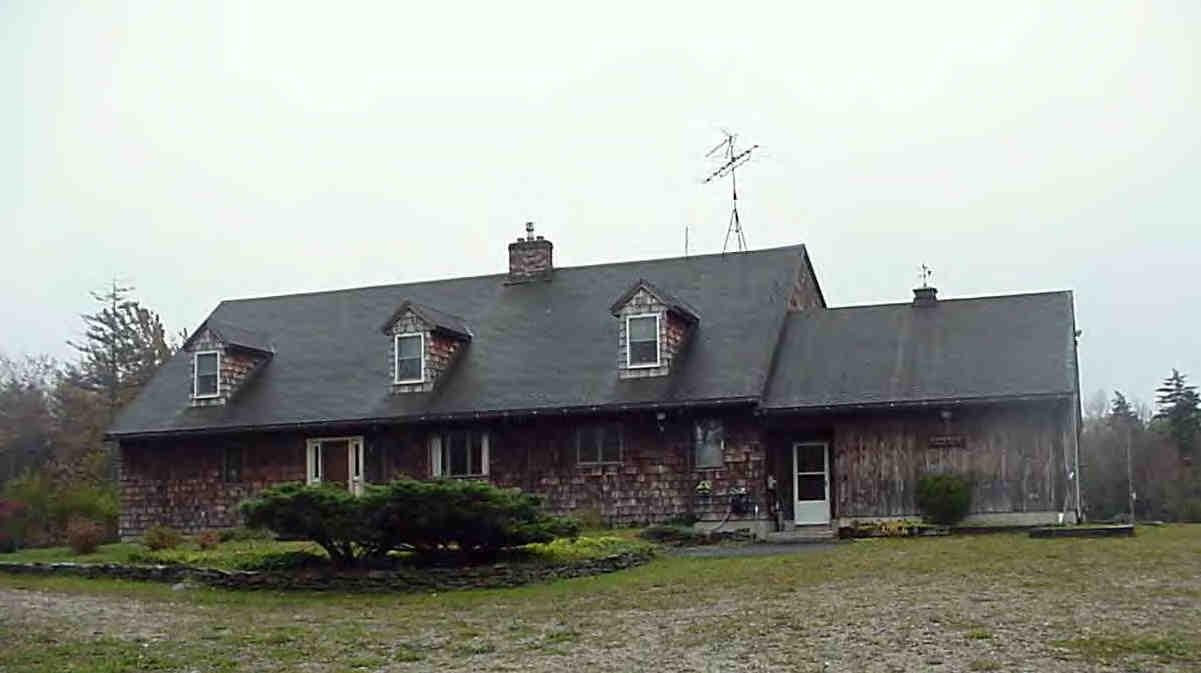 108 East Windsor Road Peru, MA 01235 - Photo 1 of 2 a front view of a building with lots of trees