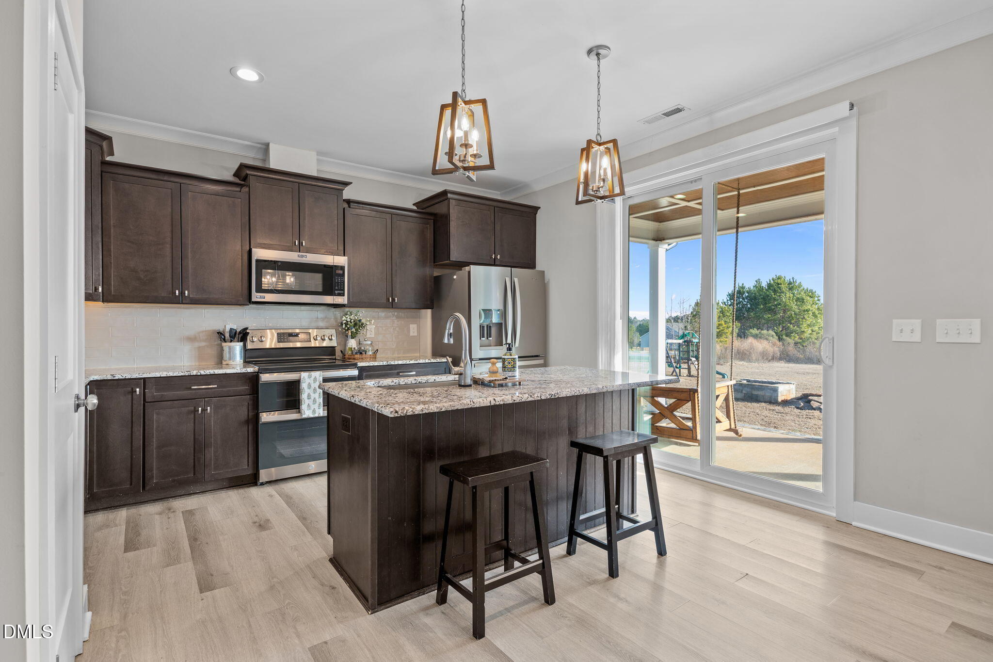 363 Mulberry Road Spring Hope, NC 27882 - Photo 11 of 35 a kitchen with kitchen island granite countertop a sink stove and refrigerator