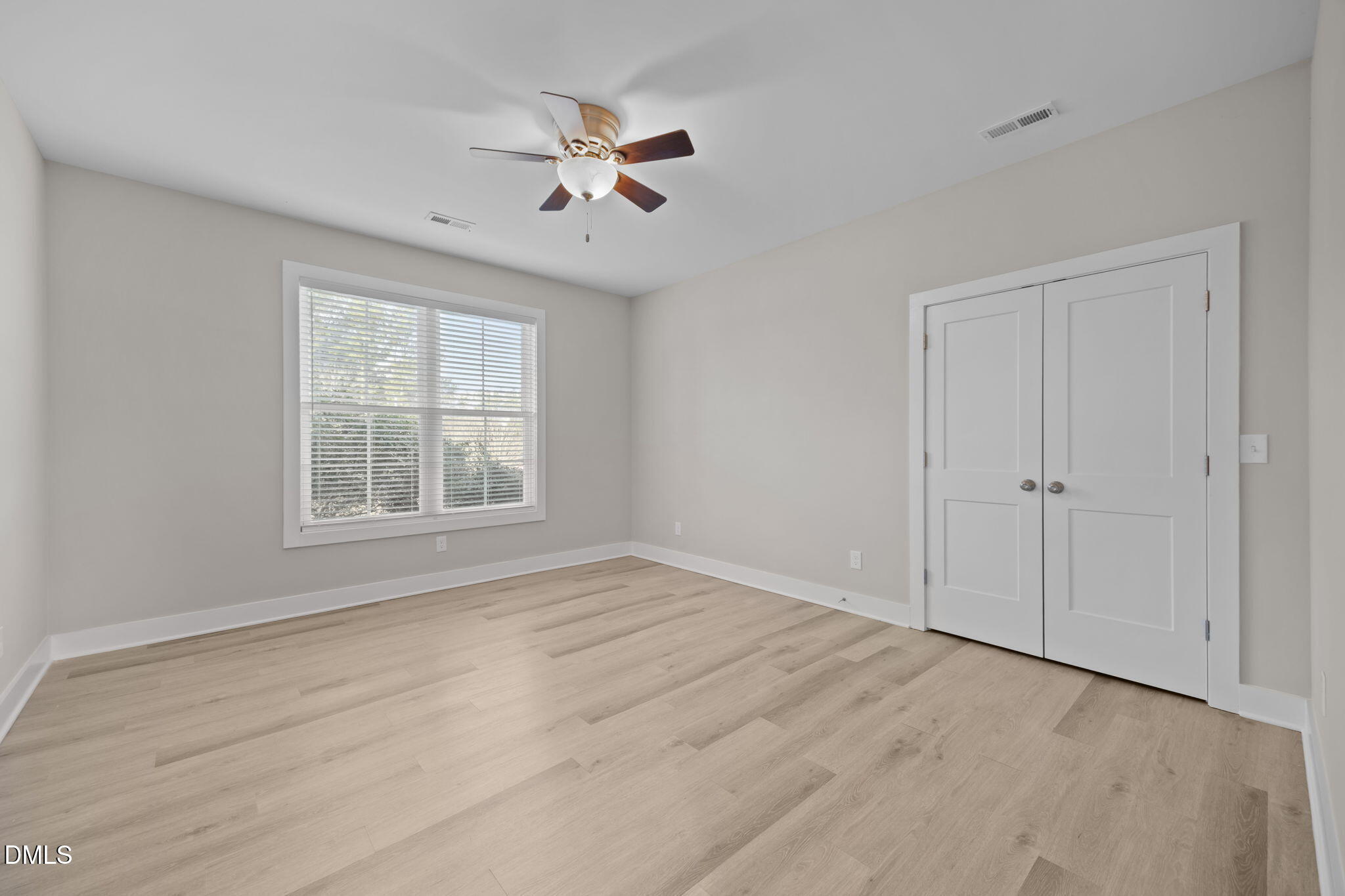 363 Mulberry Road Spring Hope, NC 27882 - Photo 17 of 35 a view of an empty room with chandelier fan and wooden floor