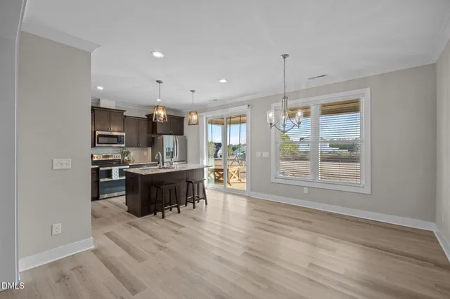 a large kitchen with kitchen island a sink stainless steel appliances and cabinets