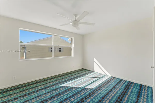 a view of a room with wooden floor and white walls