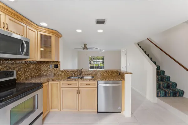 a kitchen with stainless steel appliances granite countertop a stove and a sink