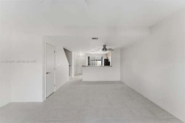a view of a kitchen with a sink and a refrigerator