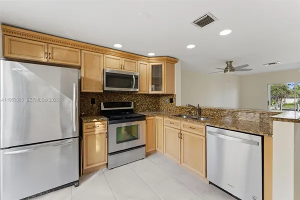 a view of a room with wooden floor and white walls