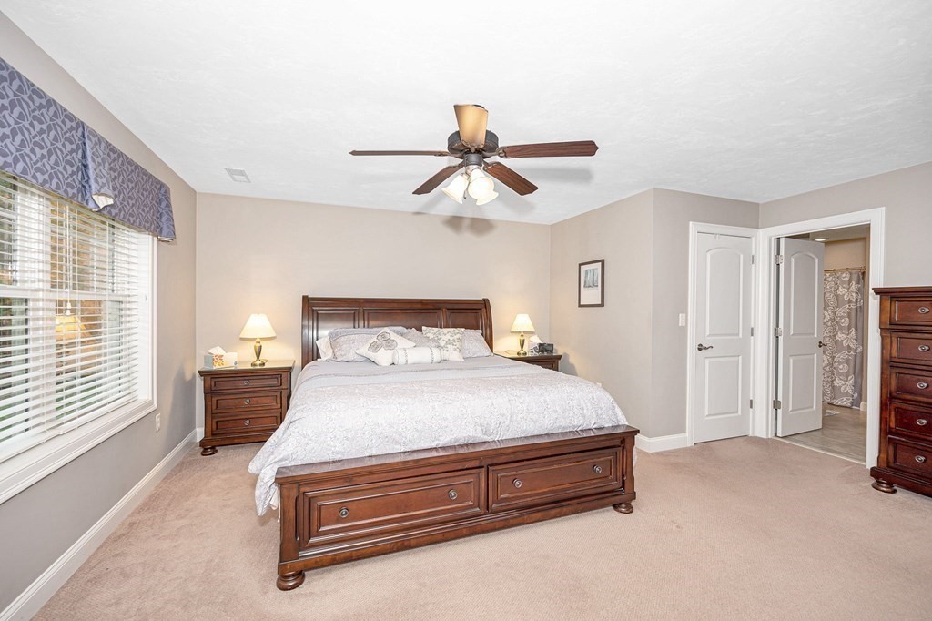 53 Baldwin Road, Unit 1701 Billerica, MA 01821 - Photo 23 of 42 a bedroom with a bed and a chandelier