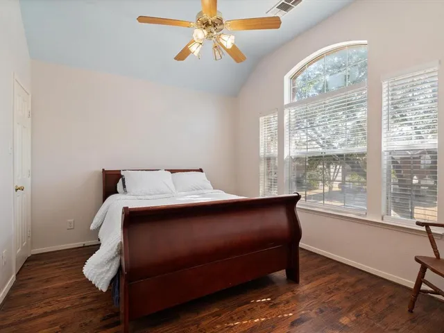 a bed sitting in a bedroom next to a window